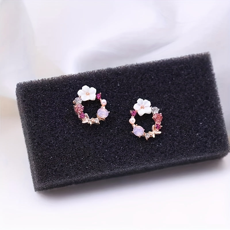 Stud earrings with floral motif and gemstone accents