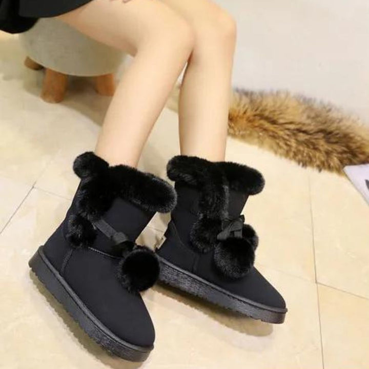 Elegant winter boots with pompom embellishment