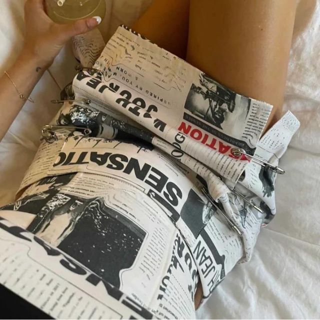 Off-the-shoulder playsuit with newspaper print