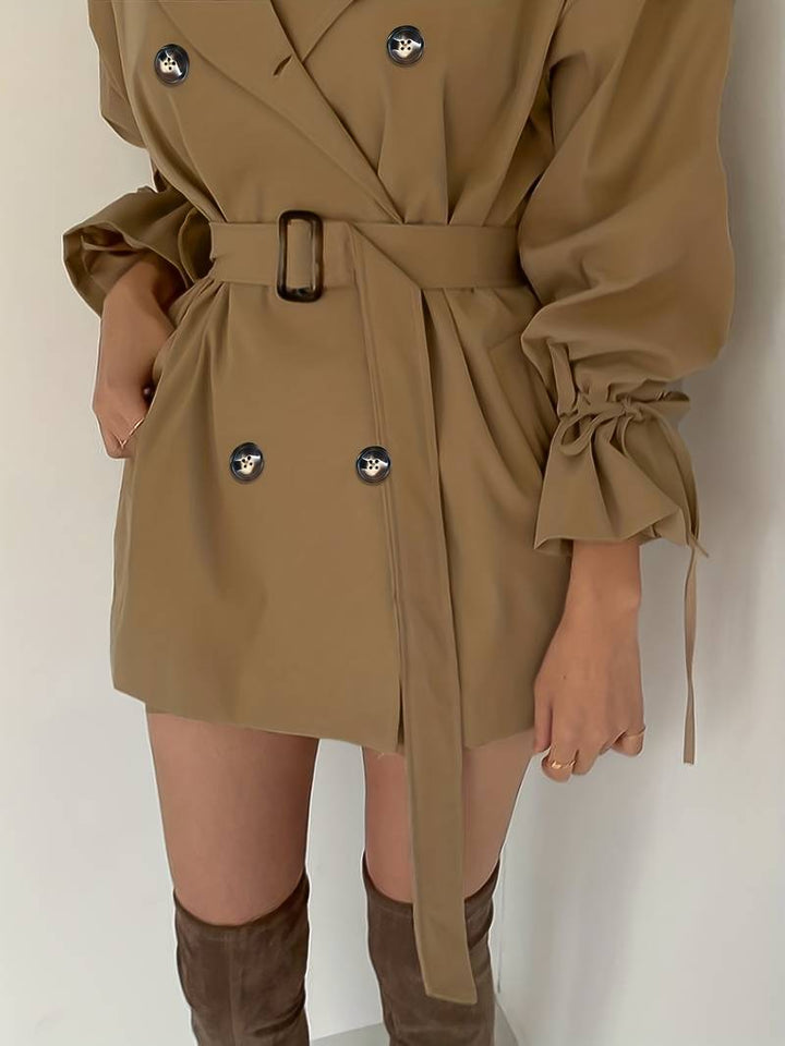 Mid-length, double-breasted trench coat with collar and belt