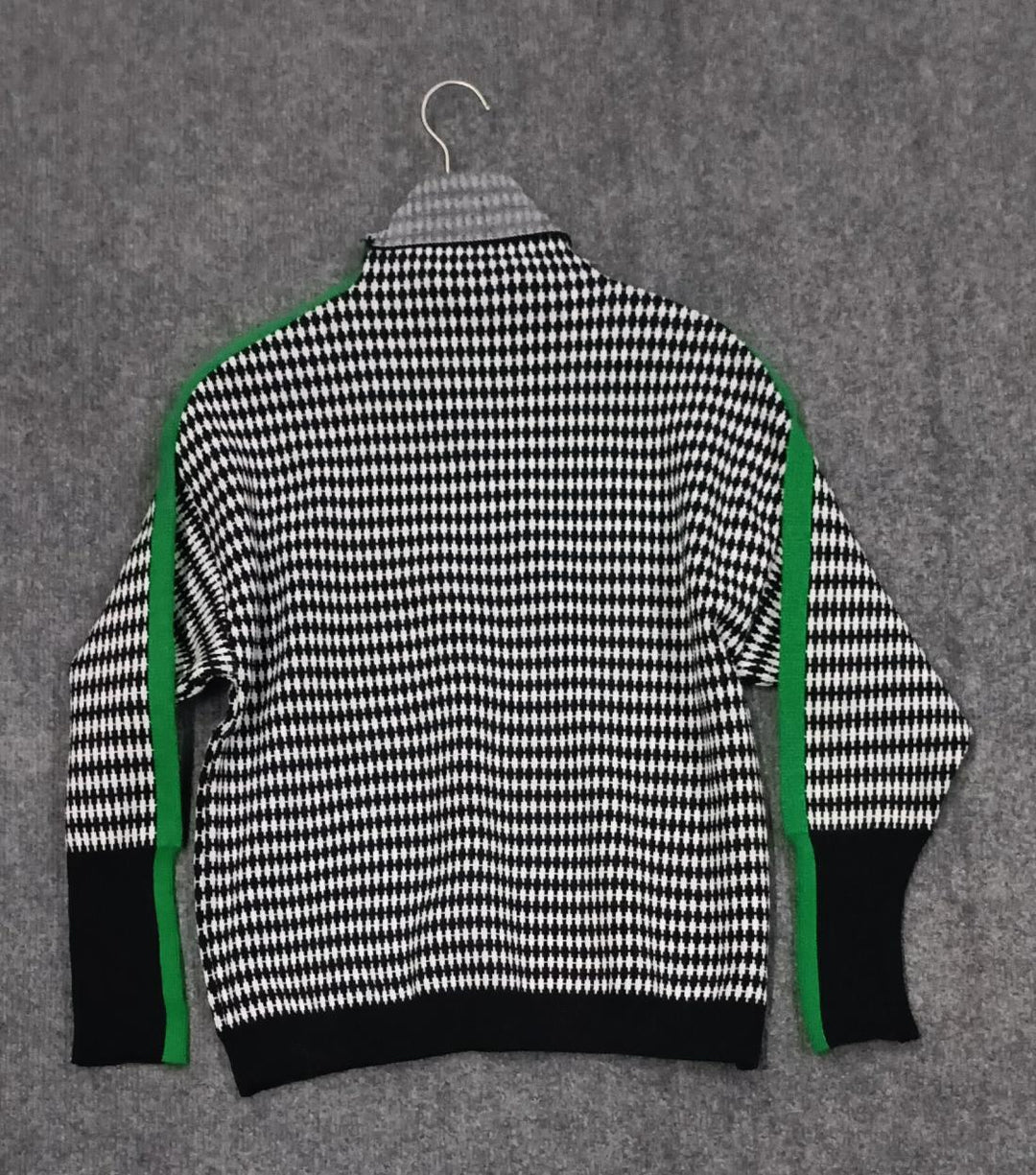 Green striped jumper with a black and white checked pattern