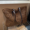 Woven carrier bag with leather straps