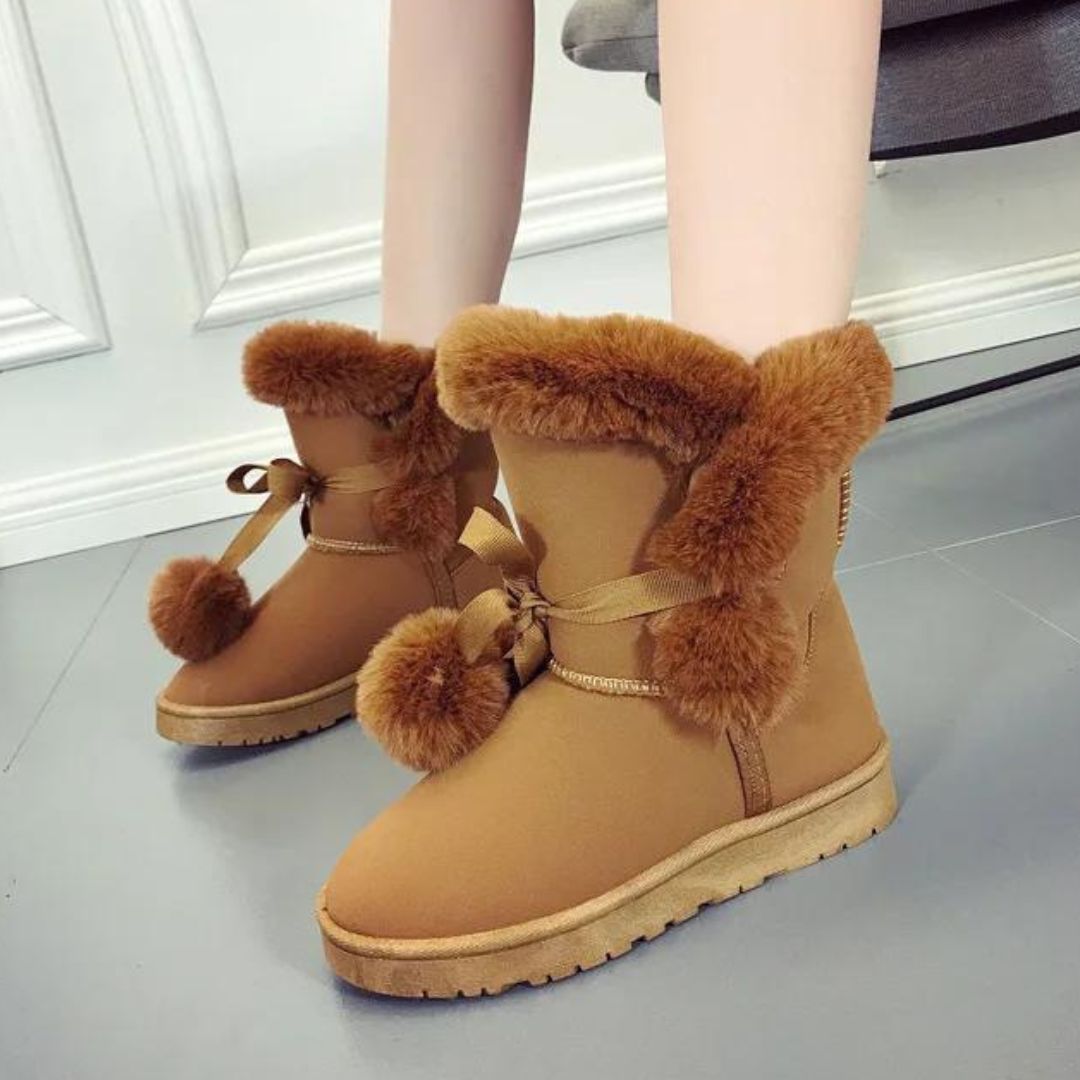 Elegant winter boots with pompom embellishment