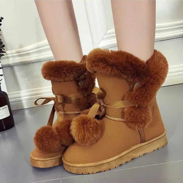 Elegant winter boots with pompom embellishment