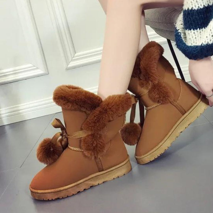 Elegant winter boots with pompom embellishment