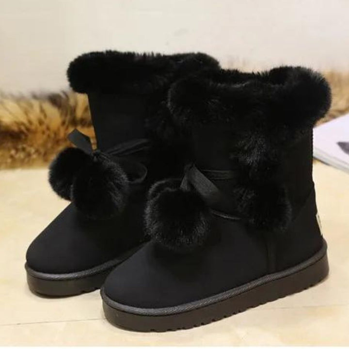 Elegant winter boots with pompom embellishment