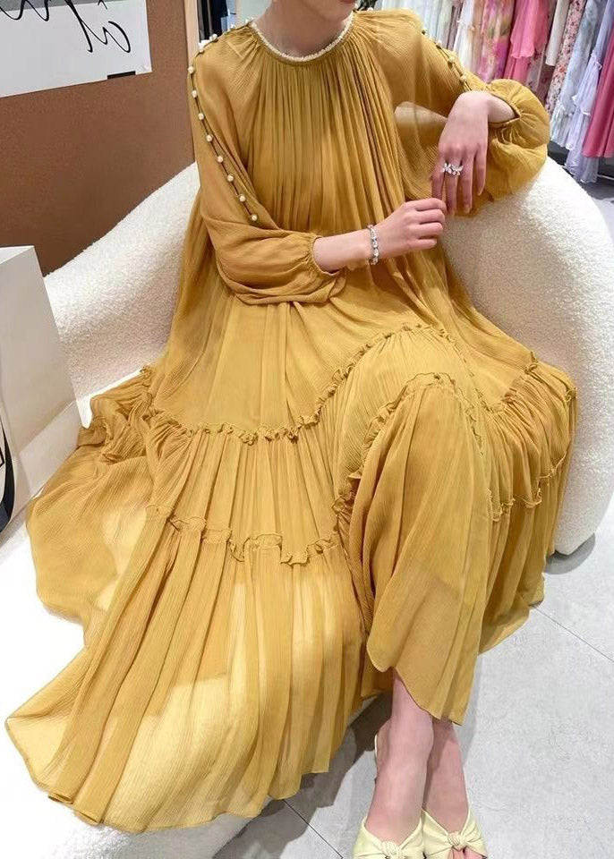 Gathered yellow silk dress with long sleeves