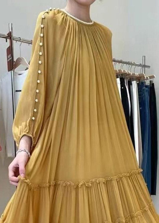 Gathered yellow silk dress with long sleeves