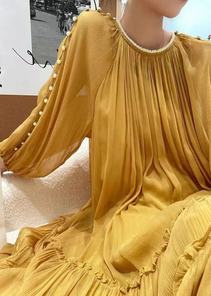 Gathered yellow silk dress with long sleeves