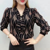 Wave pattern V-neck blouse with pearl embellishment