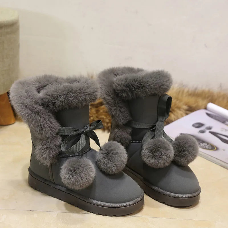 Elegant winter boots with pompom embellishment