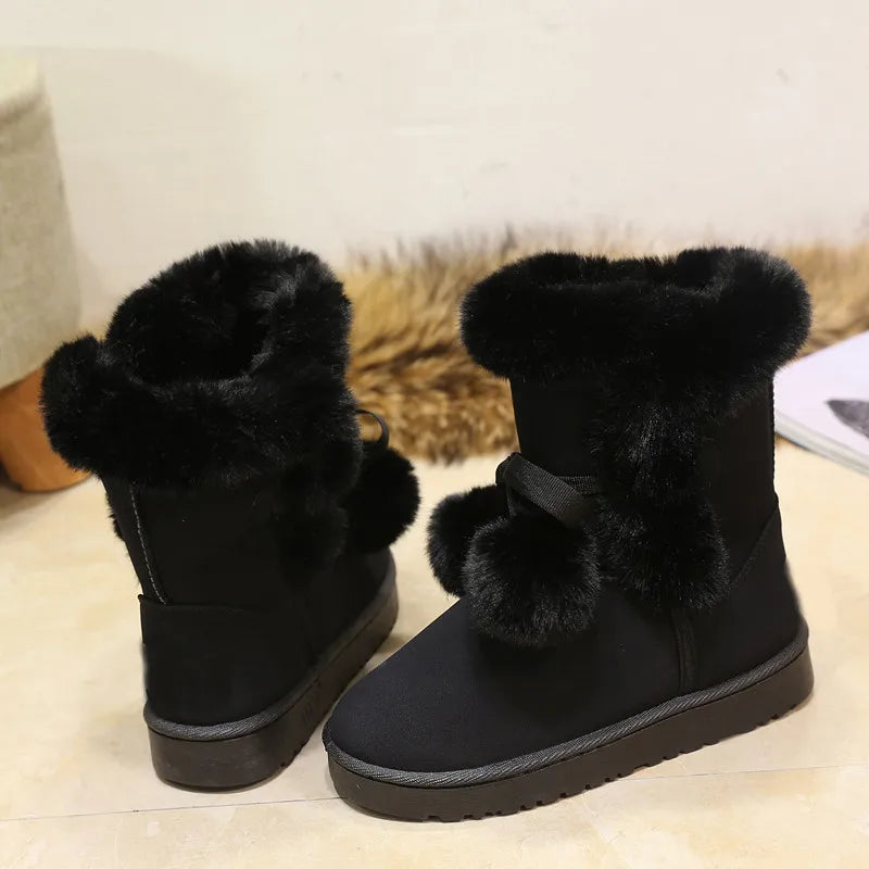 Elegant winter boots with pompom embellishment