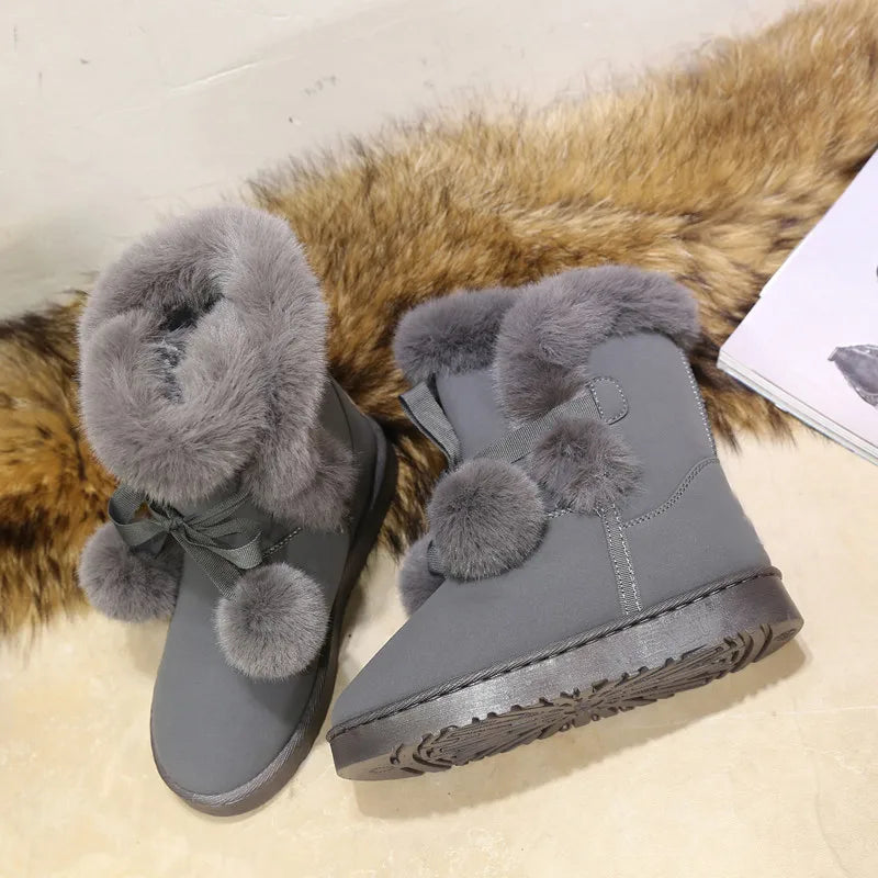 Elegant winter boots with pompom embellishment