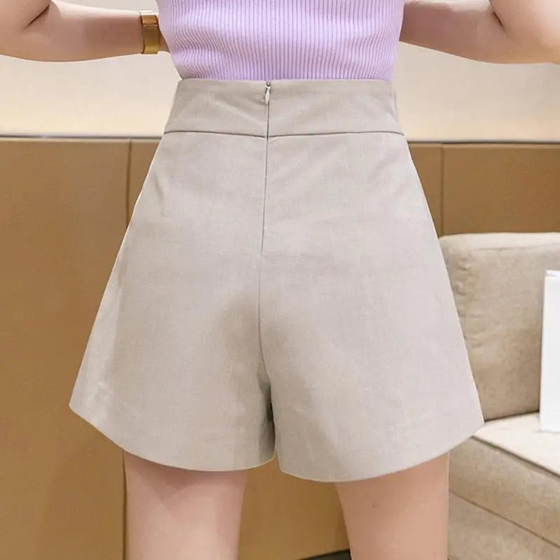 High waisted shorts with pleats and button detail