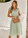 Light green mid-length dress with V-neckline