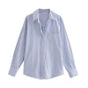 Striped, loose-fitting women's shirt: long-sleeved button blouse with pocket