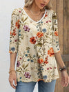 Top with half sleeves, V-neck and floral pattern