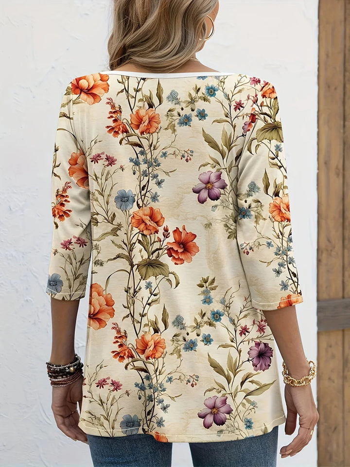 Top with half sleeves, V-neck and floral pattern