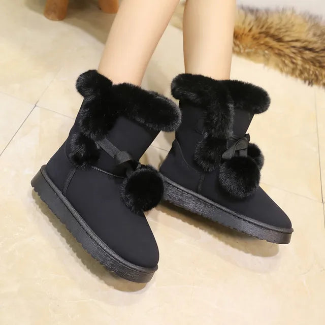 Elegant winter boots with pompom embellishment