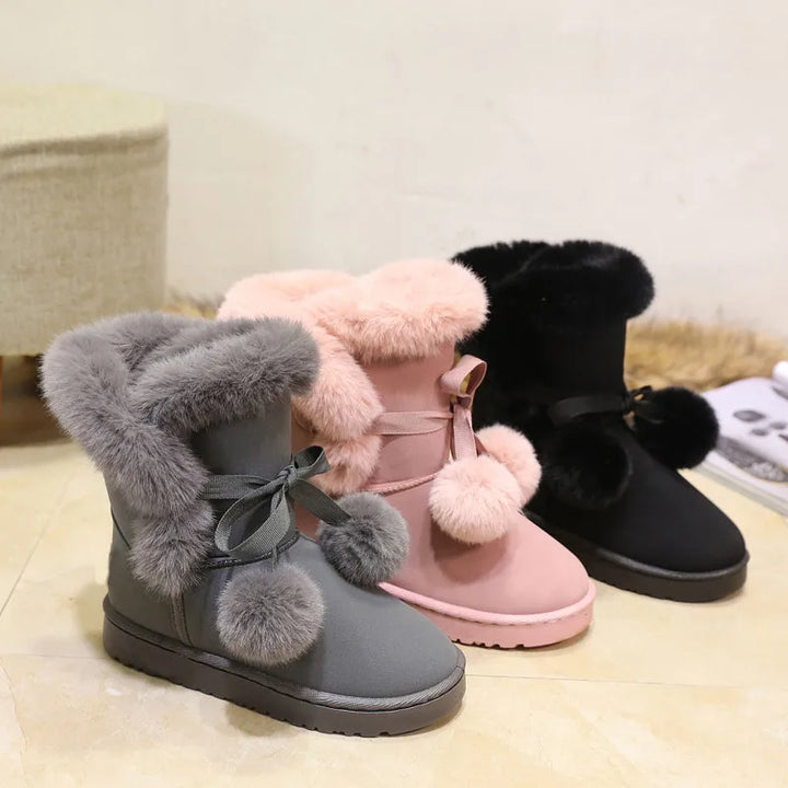 Elegant winter boots with pompom embellishment