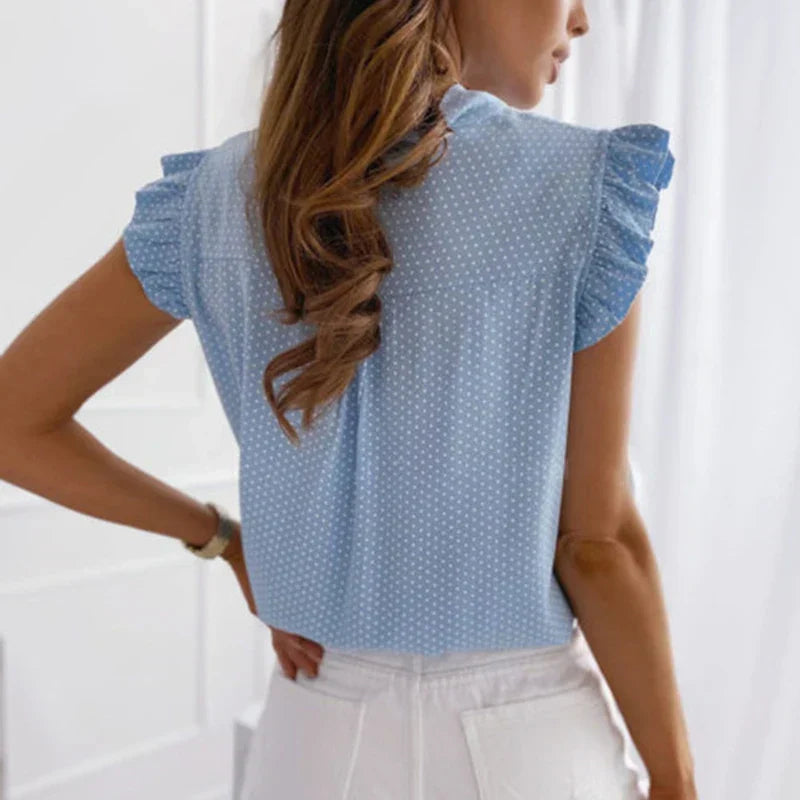 Women's summery sleeveless blouse with polka dots, ruffles and bow detail