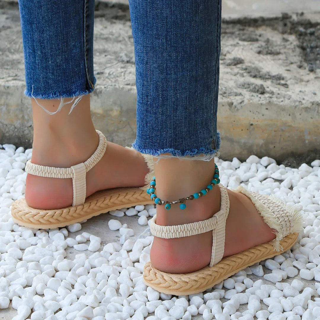 Sandals with tassels and flat heel