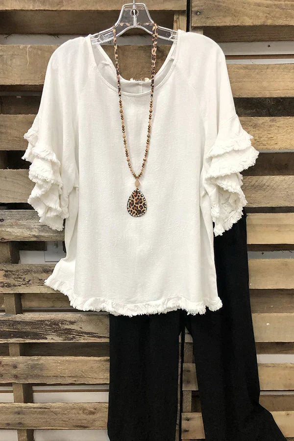 Ruffled cotton blouse with a round neckline