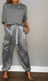 Two-piece suit in smooth satin with half-length top and trousers for women