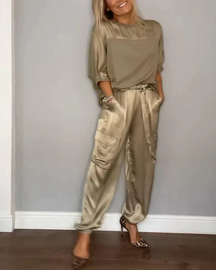 Two-piece suit in smooth satin with half-length top and trousers for women