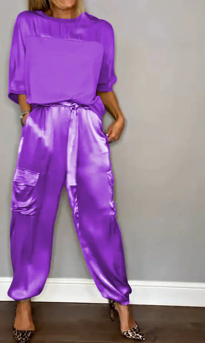 Two-piece suit in smooth satin with half-length top and trousers for women