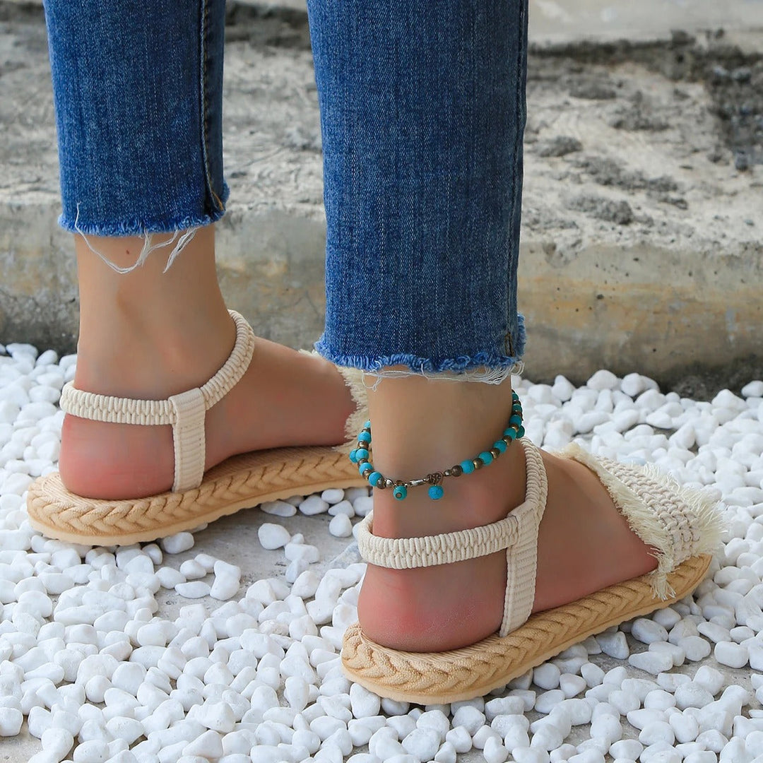 Sandals with tasselled laces