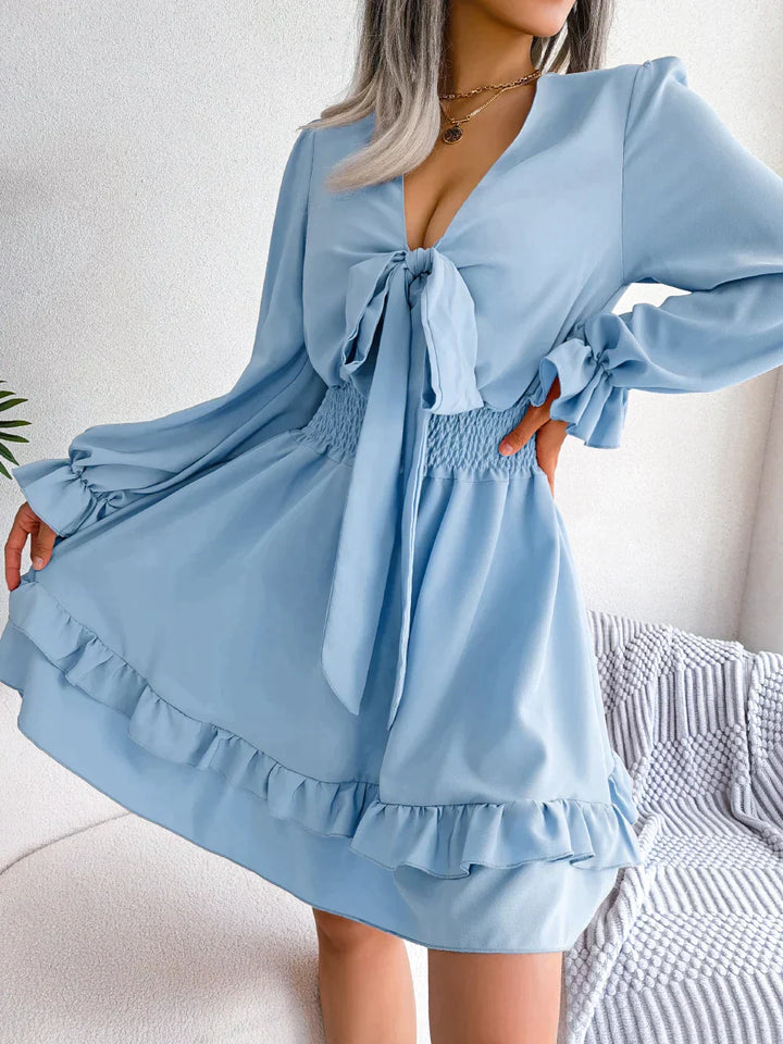 Dress with plunging neckline and ruffles