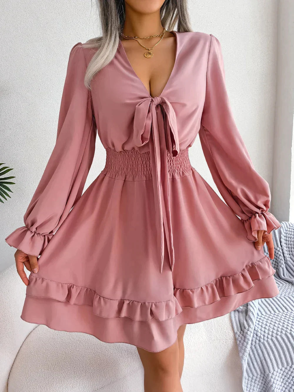 Dress with plunging neckline and ruffles