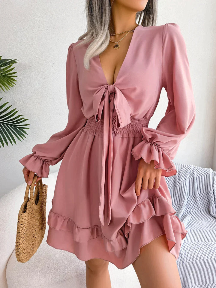 Dress with plunging neckline and ruffles