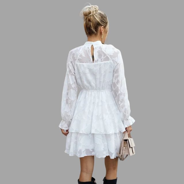 Flowing tiered mini dress with embossed floral detail